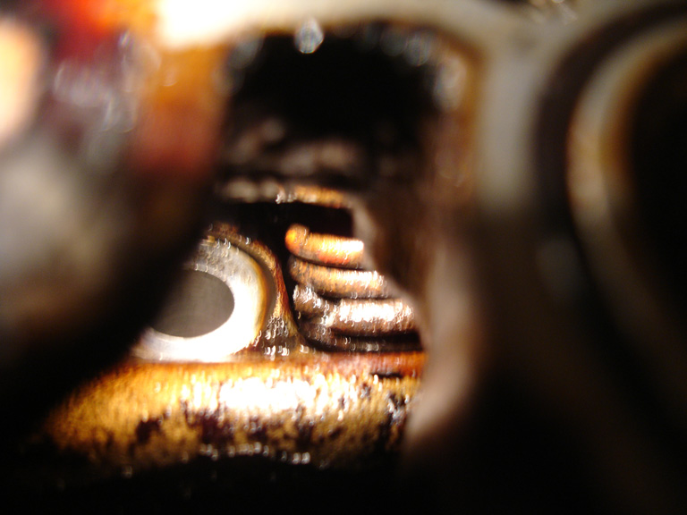 The broken spring - it looks collapsed, maybe broken in a couple places?