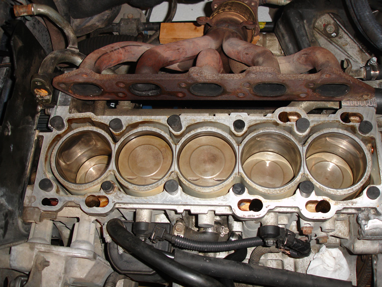 The block, midway through the cleaning process. The top of #2 did not seem to have piston-valve contact. With the broken spring, the exhaust valve was sitting open.