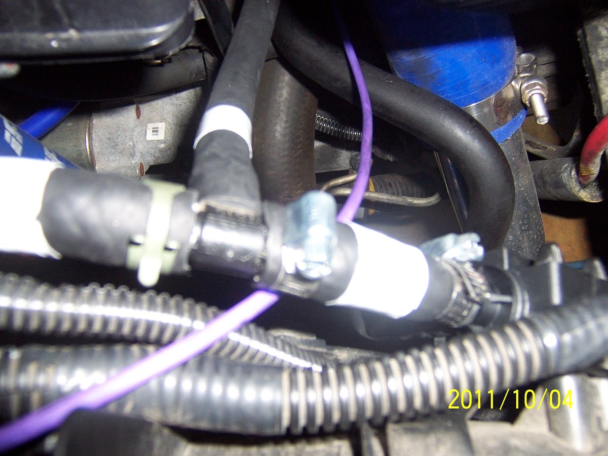 The T-shape and hoses marked with white tape ( one small end to Purge Valve) the other is larger to the T-bar