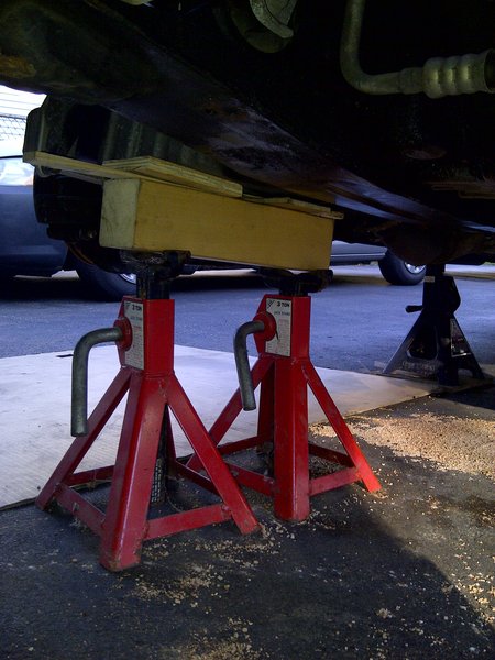 Jack stands holding the block up.