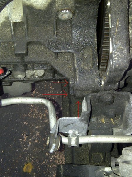 Front of engine.  There is another bolt right above the sub frame.  You can see it easily from under the car.  Sorry I don't have a better picture.