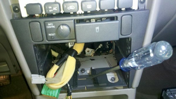 The center screw has to be removed. The motor (written about in other threads) that controls the temp is directly under the cup holder.