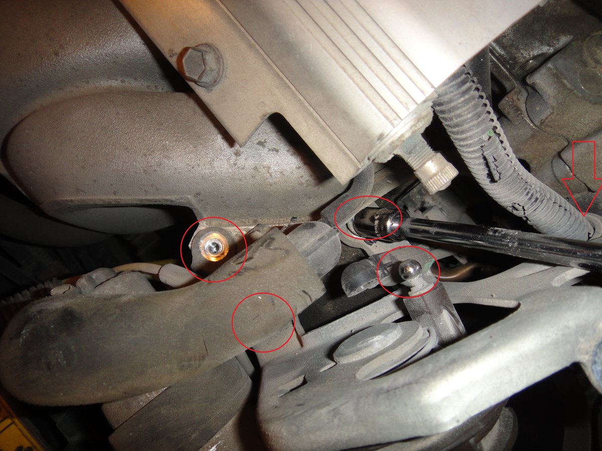 Pop the link to the throttle body with a screwdriver, make sure not to twist it or bend up the link. there are 3 screws that hold in the cable section. undo the three, as well (what the arrows point too) the wire harness.  Take off whatever vacuum lines needed to get the bolts off, remember where they go.