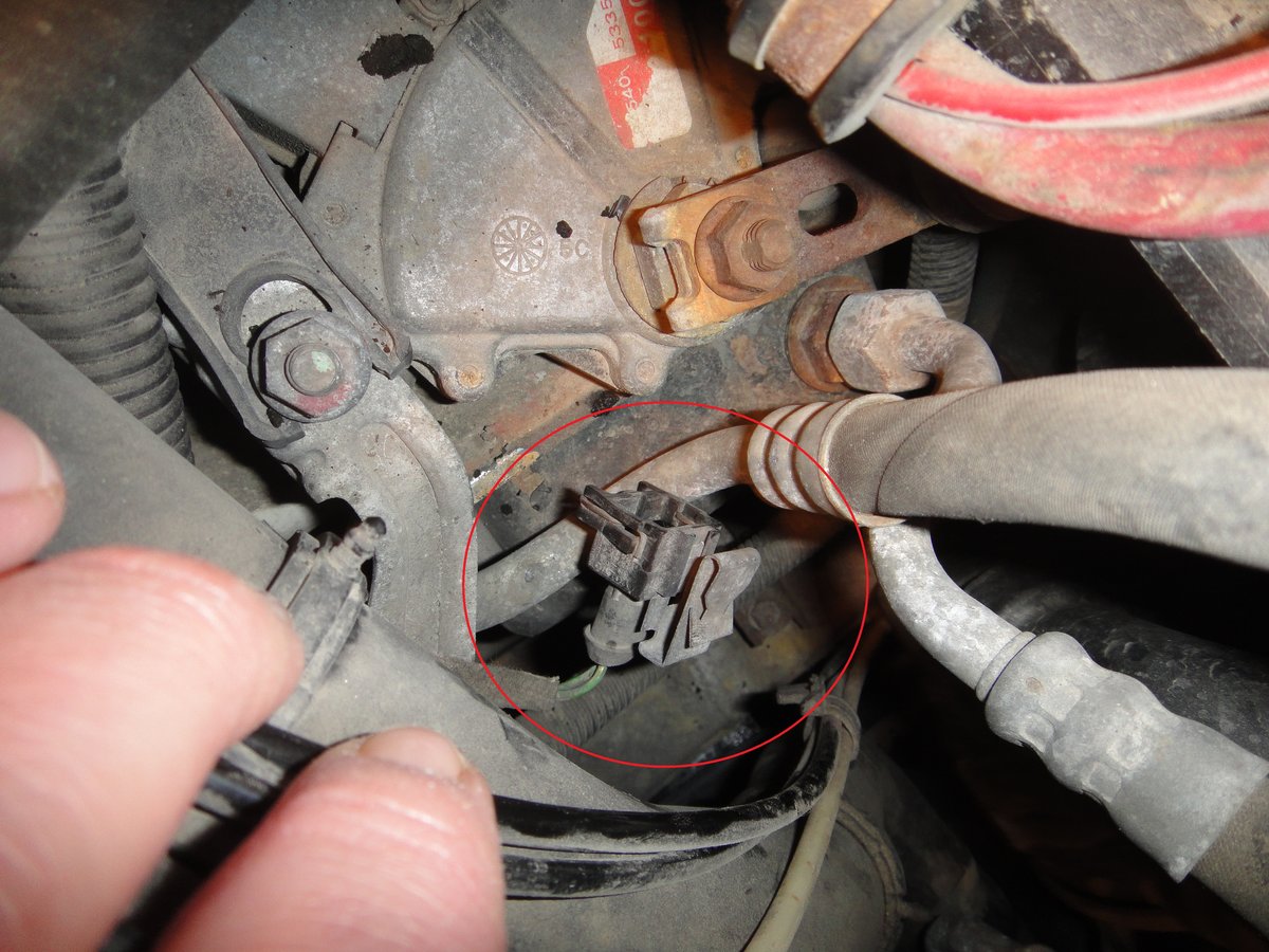 Now that the EGR is exposed, follow the Temp sensor, back to its connection, (over by the battery) Unplug it, and untangle it through the wire and hose mess you've created.