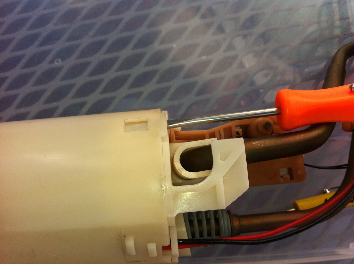 Separating the plastic housing using a small flat blade screwdriver.