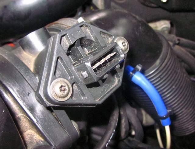 Light corrosion visible on metal pins of MAF sensor connector.