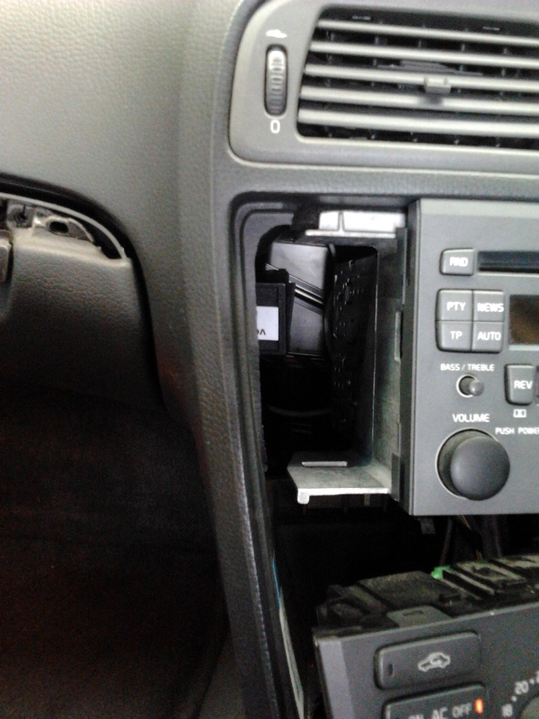 You can just see the white AUX adapter sticker (cup holder removed)