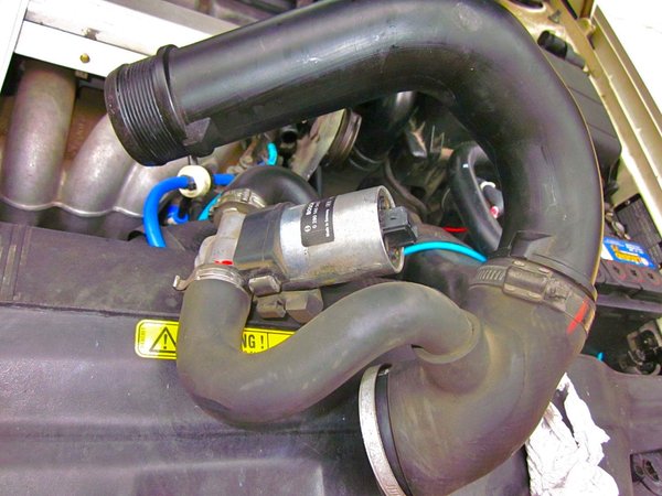 IAC and hoses after disconnecting electrical connector and hose from throttle.