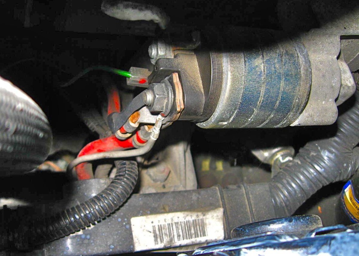 Original cable at starter, after cover removal.