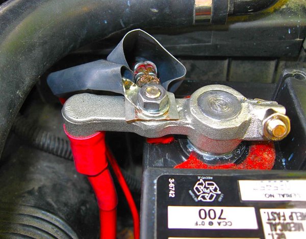 New positive terminal at battery with flattened ears on cable.