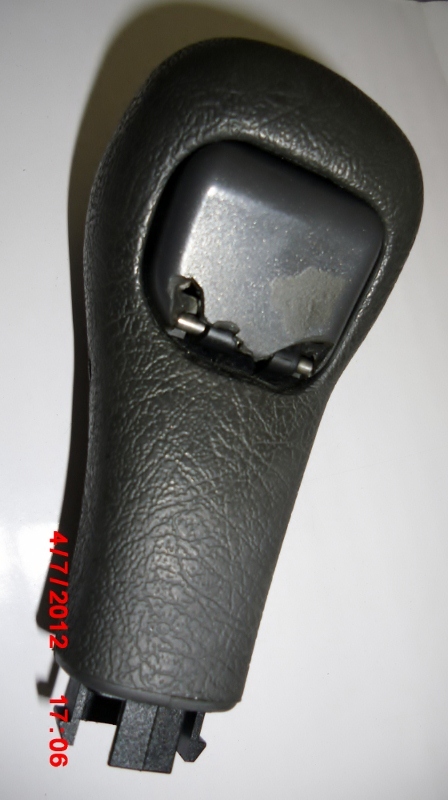 Broken bottom of the shift knob button.