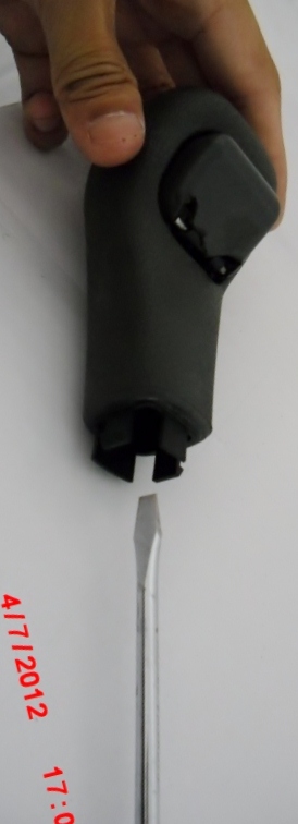 Stick the screwdriver straight in to release.