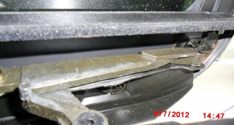 You can see a metal standoff to the right where the plastic shields snap on/off the sunroof raising mechanism.