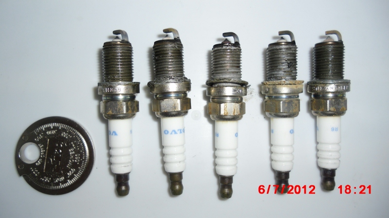 Spark plug gap gauge and old plugs lined up 1-5. The infamous #3 plug has the most carbon, probably because it's in the center and hottest part of engine.