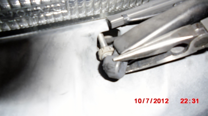 Cover over the headlight wiper nut.