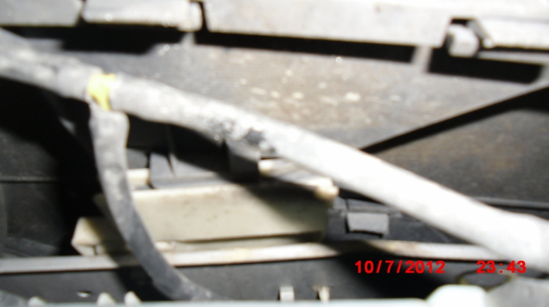 T-connection from bottom of washer fluid tank, one to windshield and the other to headlights.