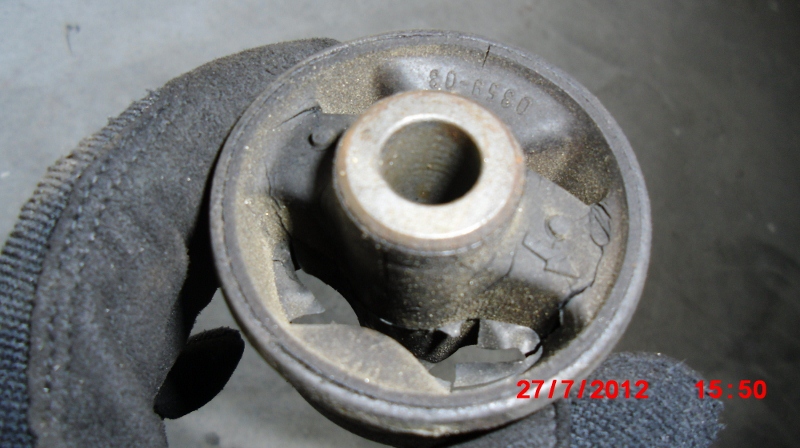 Worn out OEM upper engine mount: breaks, cracks, and rips.