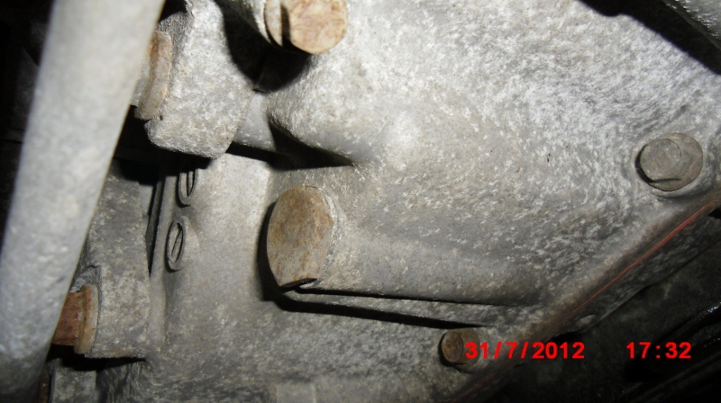 ATF drain plug on the bottom right edge of the transmission case. Notice the crush washer, I re-used it.