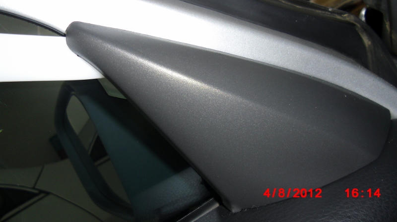 Popping off side view mirror interior trim of a 1998 V70 XC using a bone tool.