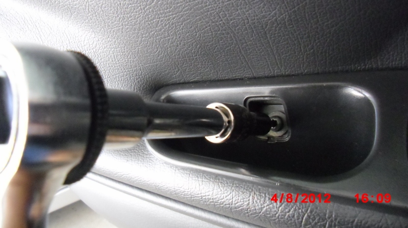 Removing T20 screw off the interior door trim of a 1998 V70 XC. Now is a good time to pop off the master window switch.