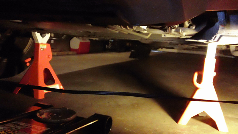 two jack-stands located near control arm supporting the subframe