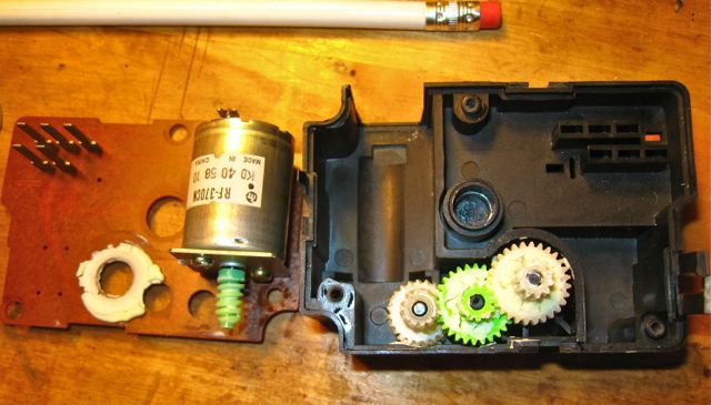 Dried caked white grease on gears inside Damper Motor.