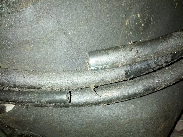 Passenger side of the car. Fuel supply and return line. Vacuum-like line separated