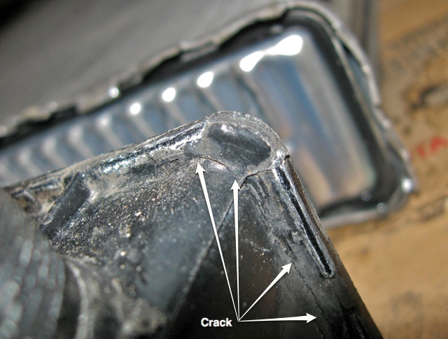 Image of inlet side endcap after removal from aluminum core, showing crack running around corner.