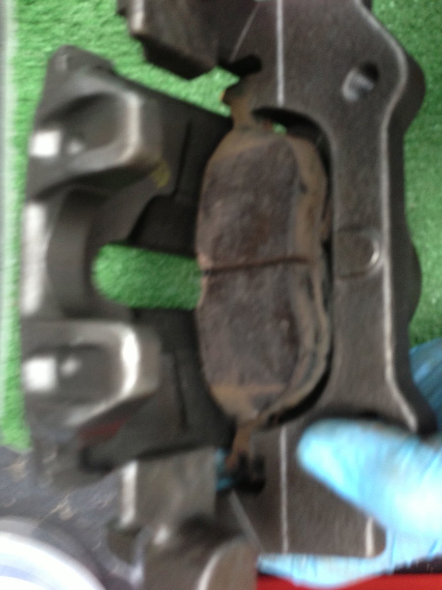 Load inboard pad into piston, use screwdriver to push springs in to slip into piston recess - sorry, hard to photo with two hands