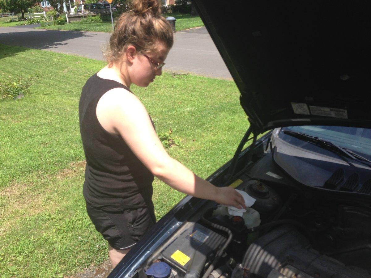 Abby tops off coolant and replaces cap - yeah - Im getting a T5 for college - :-)