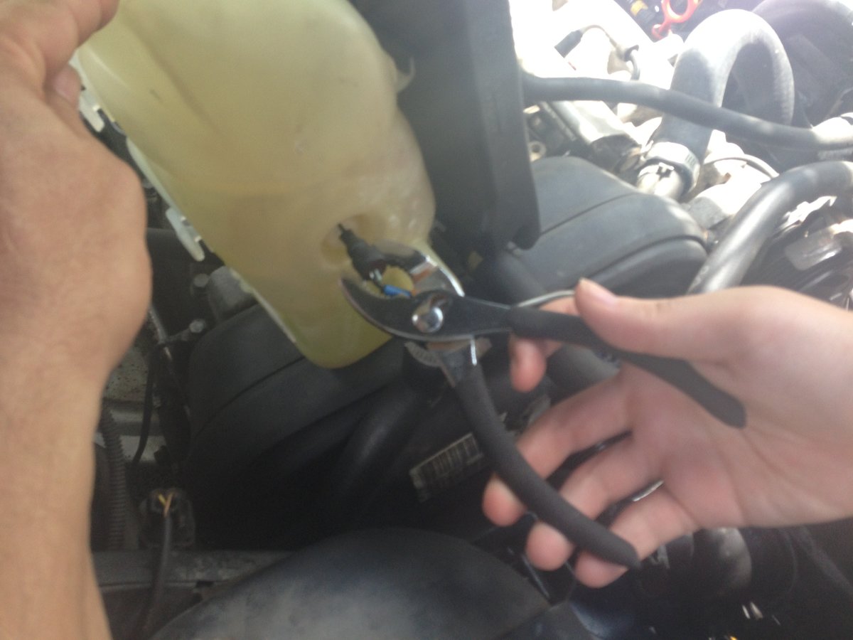 Abby removes sensor with pliers grabbing thick rubber part - new one sticks back in with finger pressure