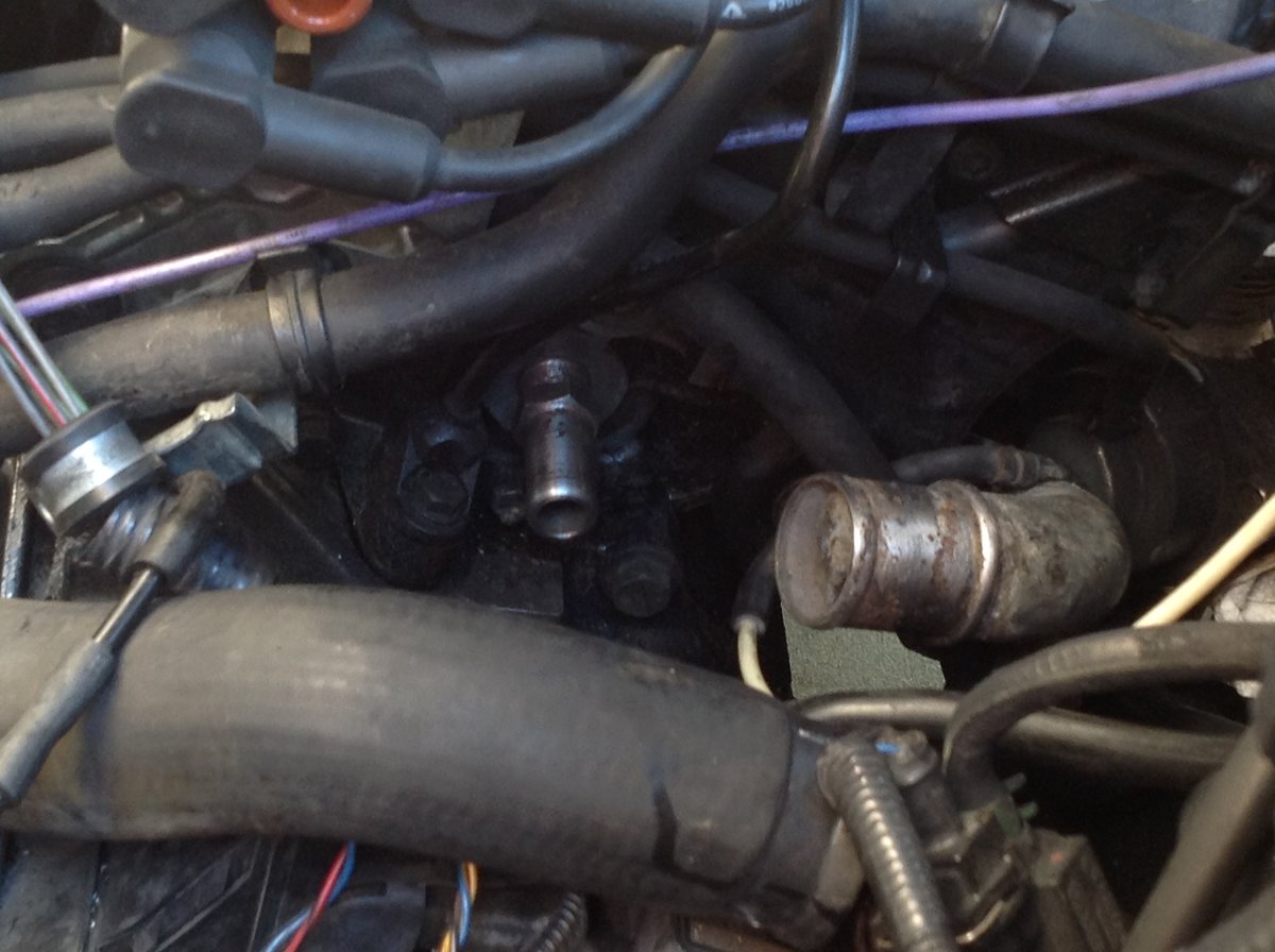 Heater Hose Fitting To Side of Engine Block Left Lower Side of Distributor Cap