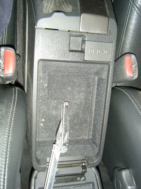 Getting ready to remove the center console assembly...there are two screws under here which basically secure the entire center assembly in place!