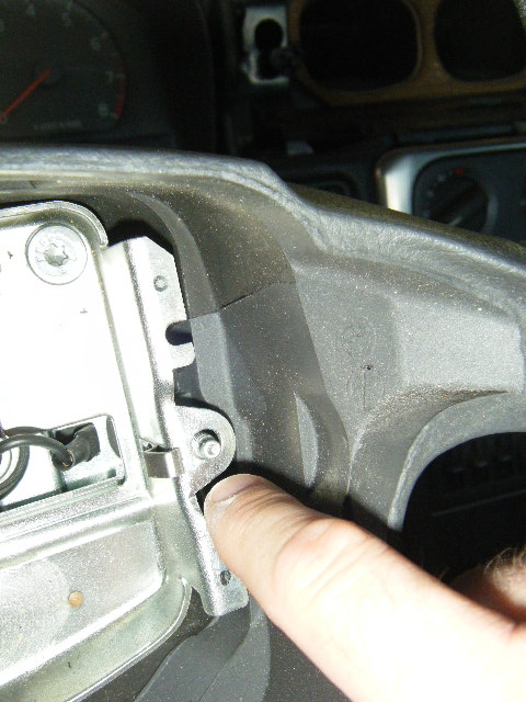 One of the "long" screws, screwed through from the back to secure the steering wheel airbag/horn assembly