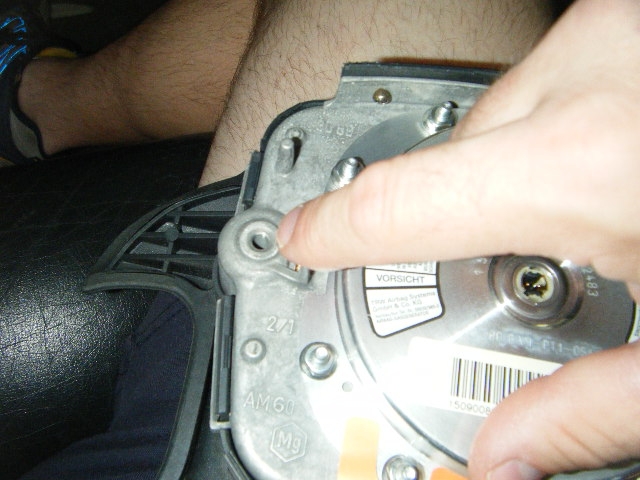 The location the long screws screw into, on the back side of the steering wheel airbag/horn assembly (one each on either side of the center)