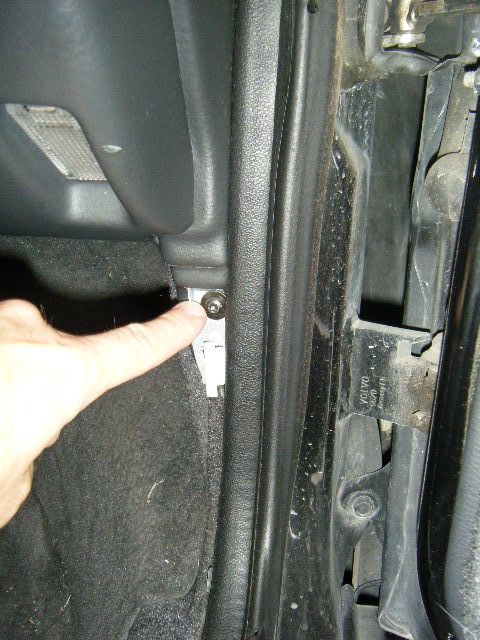 One of the lower dash retention screws exposed upon removal of the door sill plastic trim...
