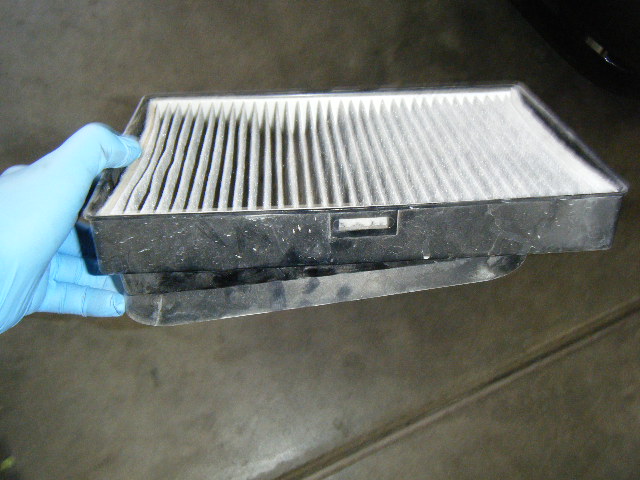 This is the displaced cabin air filter compartment, along with nasty, needs-to-be-replaced, cabin air filter (it was replaced...really!)