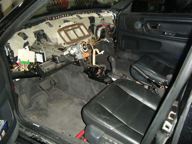 The view from the driver's side...note the four (4) openings in the upper area of the "felt-like" sound isolation/firewall "pad"...those are the locations of the four (4) primary plastic mounting tabs, where the firewall carriage bolts penetrate through and are supposed to secure the dash