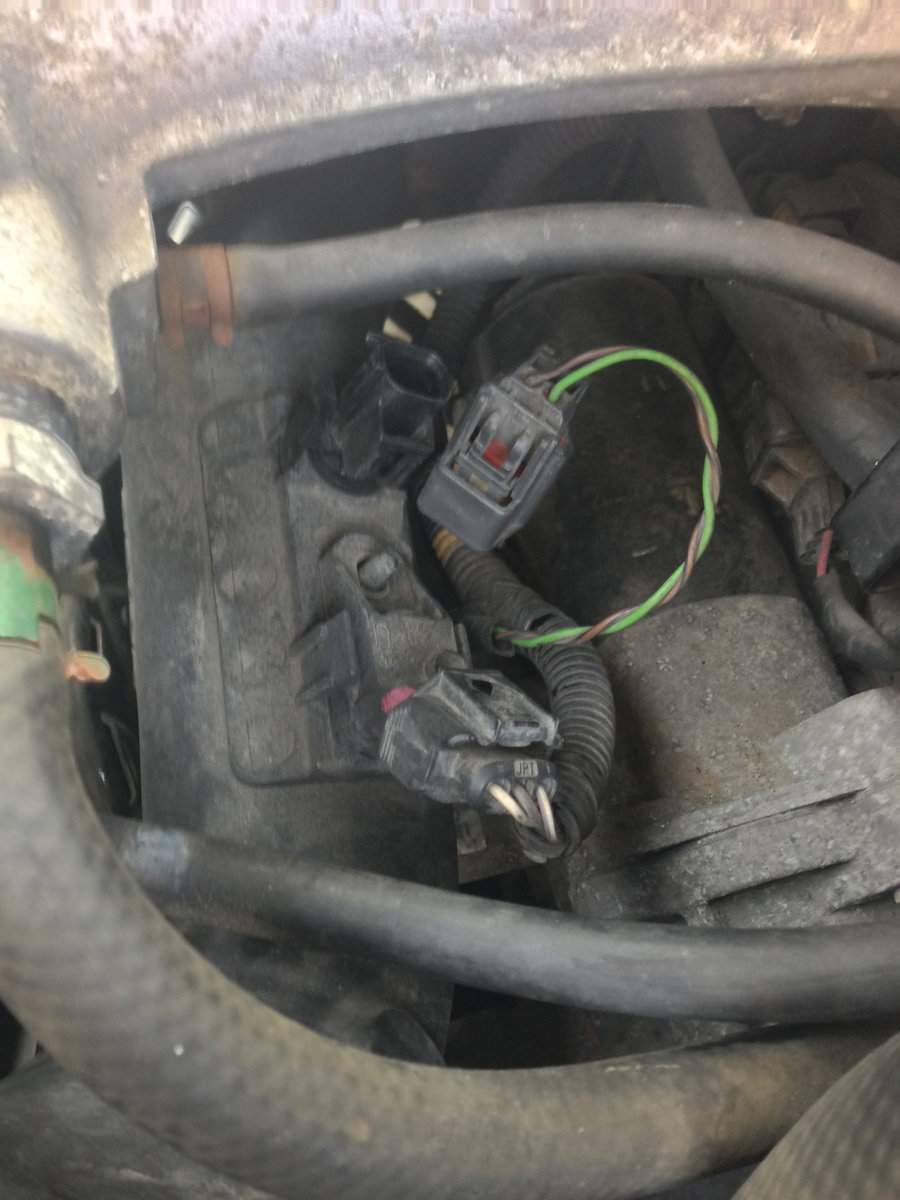 Once the IAT electrical plug is removed, squeeze the ears and lift it straight up out of the ETB manifold