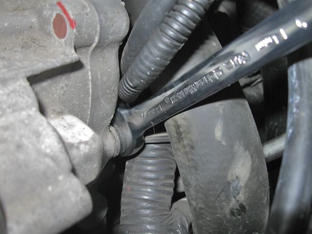 Wrench on front driver's side starter motor bolt
