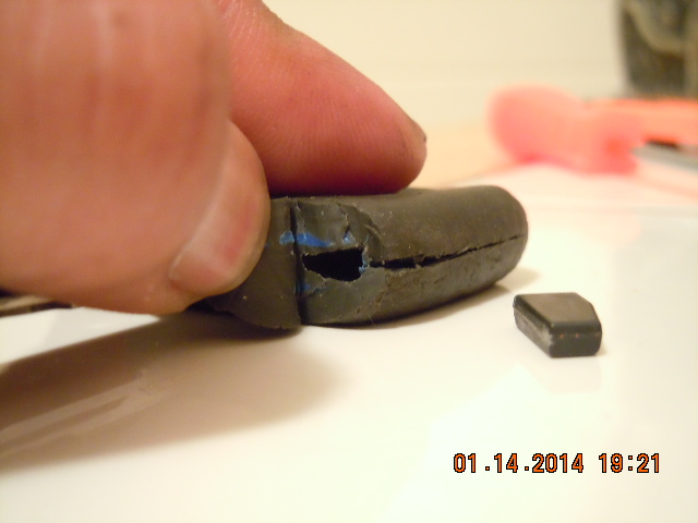 Once front of chip is exposed you make a cut above halfway down the side of key. This cut is more like scoring the gray soft area until you hit the chip itself which you will feel so do the scoring with moderate pressure because you're trying to widen the area to release the chip. After every 2 scores with "moderate" pressure you try to wedge a needle or screwdriver to widen the area as well and shortly the chip will move out by itself. Once it does just pull it out and you're done.