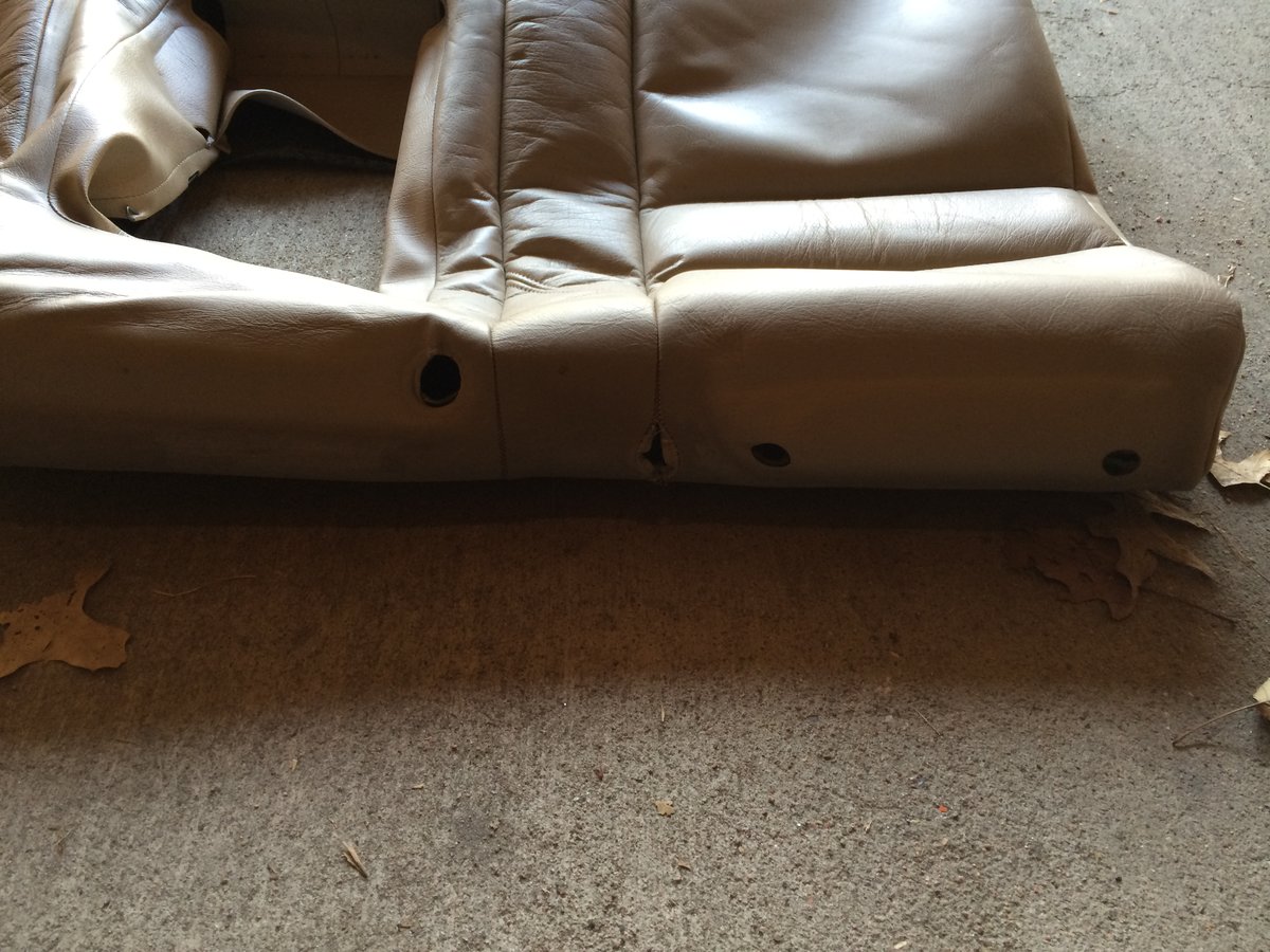 The stitching tear in top of rear seat back