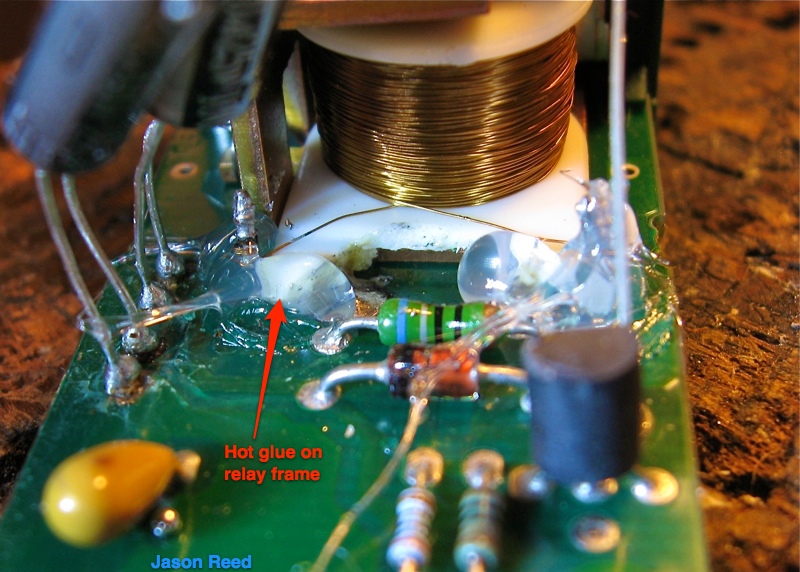 Hot glue applied between the relay frame and the circuit board