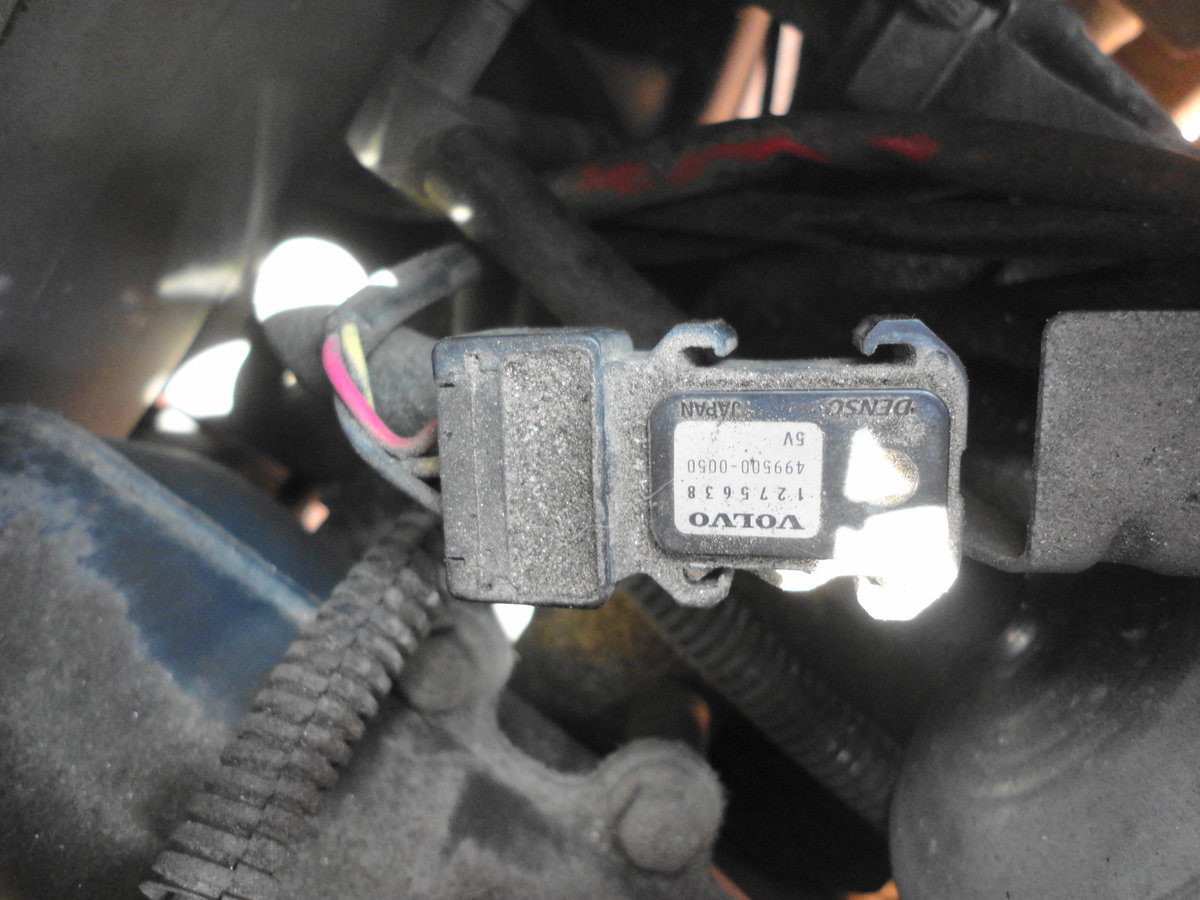 Underneath harness access door is some sort of pressure sensor held on by one 12mm bolt.  I removed this and put it out of way to gain access.