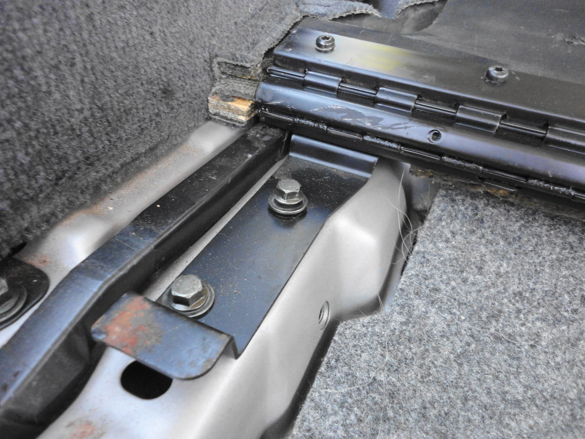 Two 10mm bolts on each side need to come off to remove wooden trunk lid.  This is necessary to get to the second access panel.