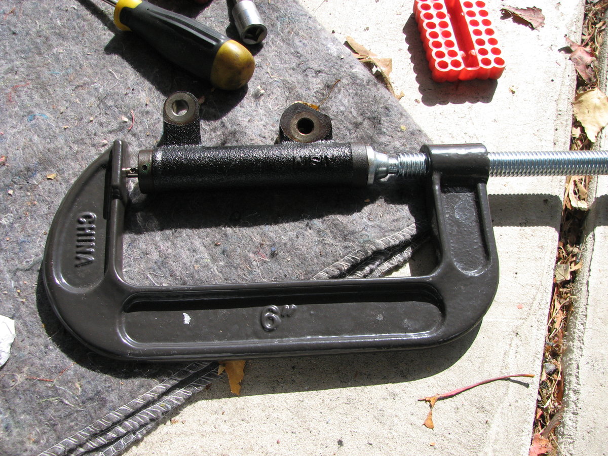 6" C clamp works great. 1/4 turn every 15 seconds until you can pin the hole.