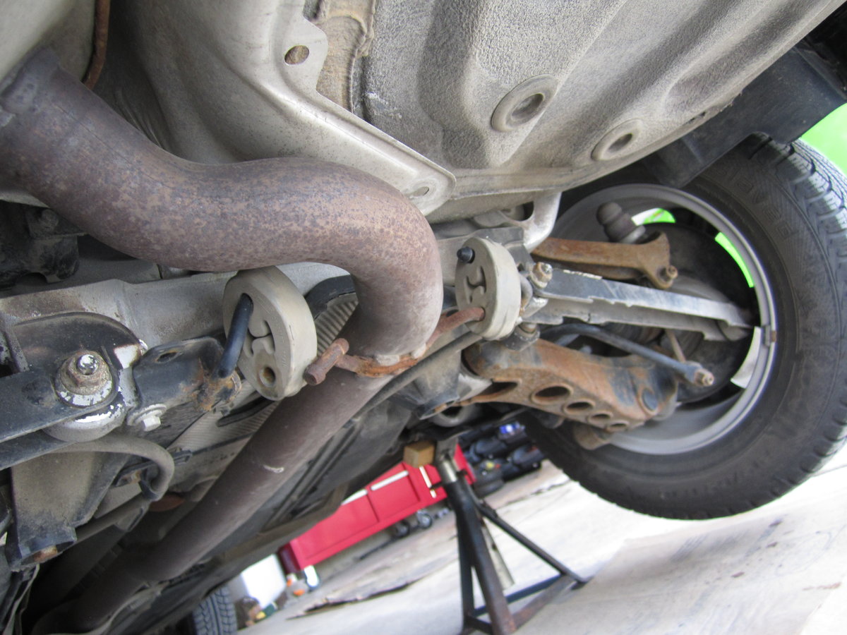 2 rubber muffler mounts rear of rear axle