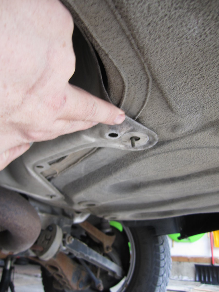 One of 2 plastic heat shield nuts to remove