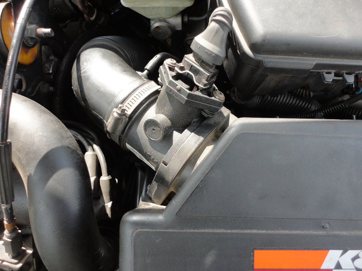 Disconnect MAF sensor and upper hose clamp.