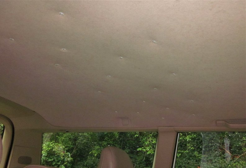 Upholstery twist pins used to hold headliner fabric up against the underlying fiber board.